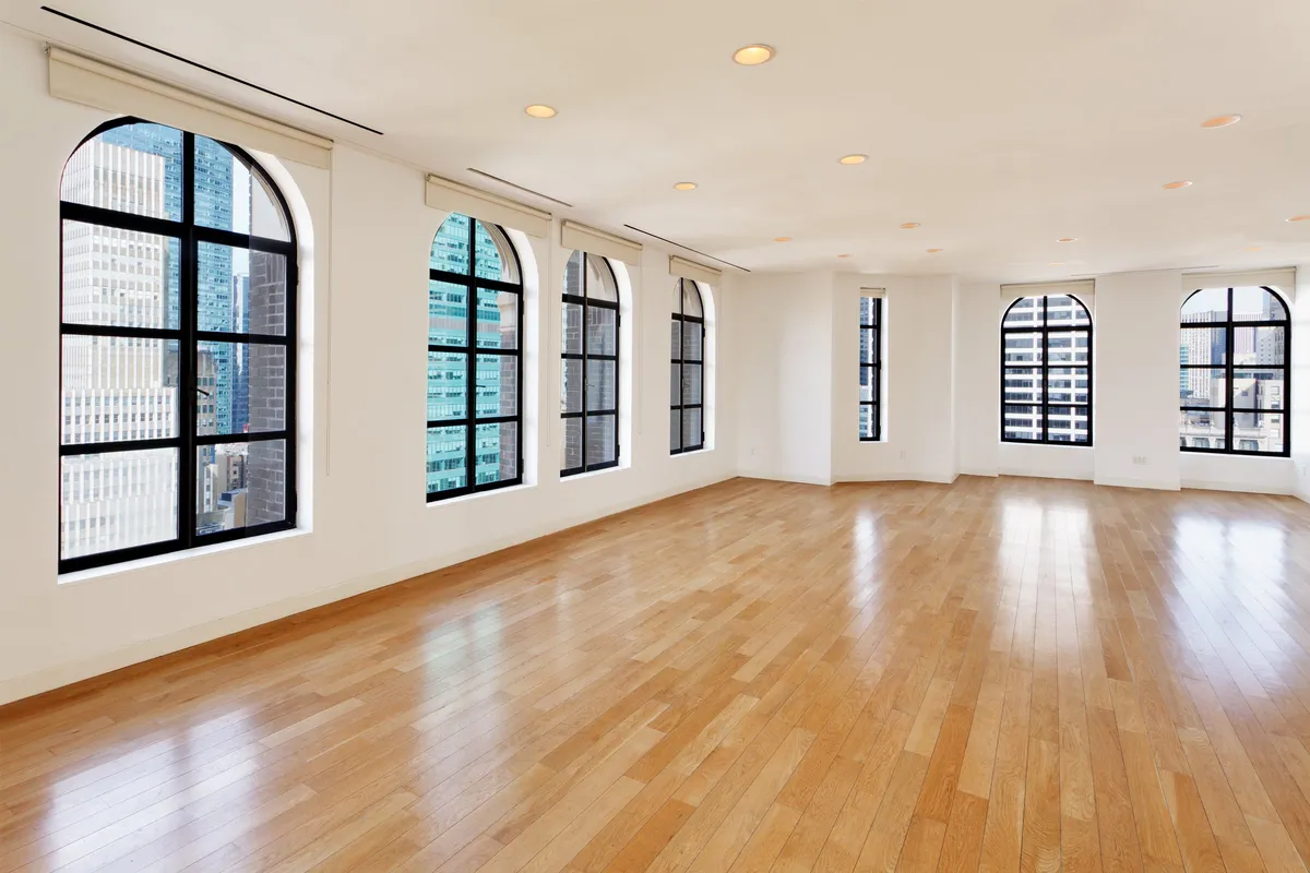 The Loft event space with arched windows overlooking the Midtown skyline