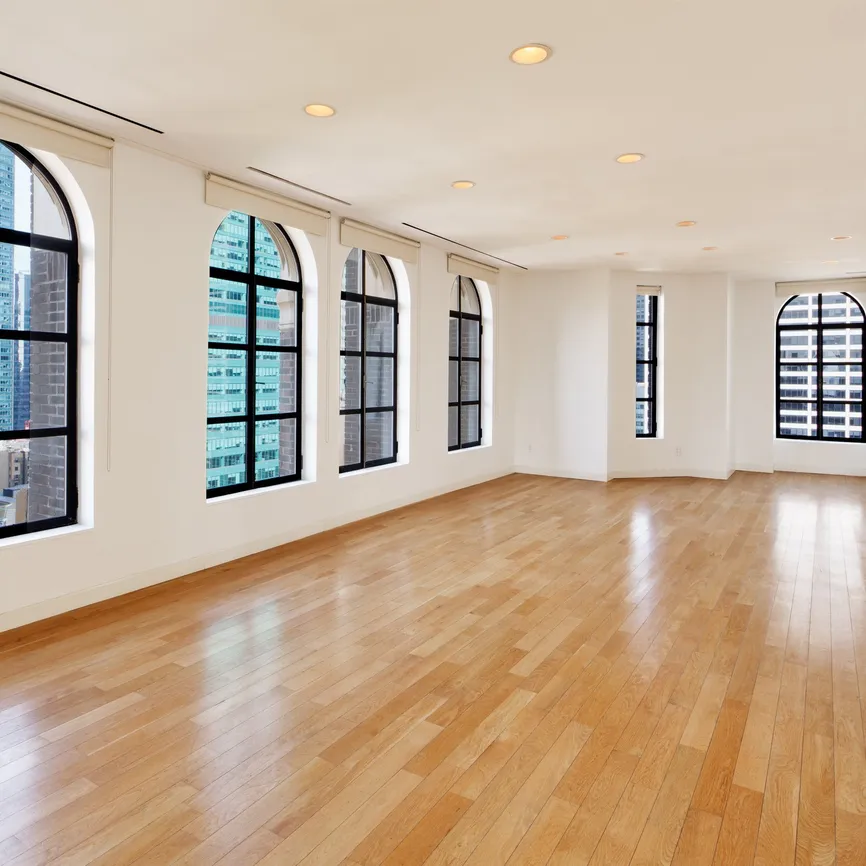 The Loft event space with arched windows overlooking the Midtown skyline