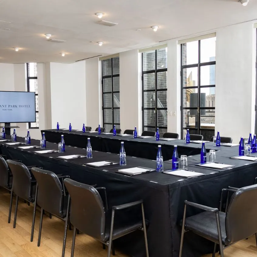 Conference Room set up boardroom-style with presentation screen