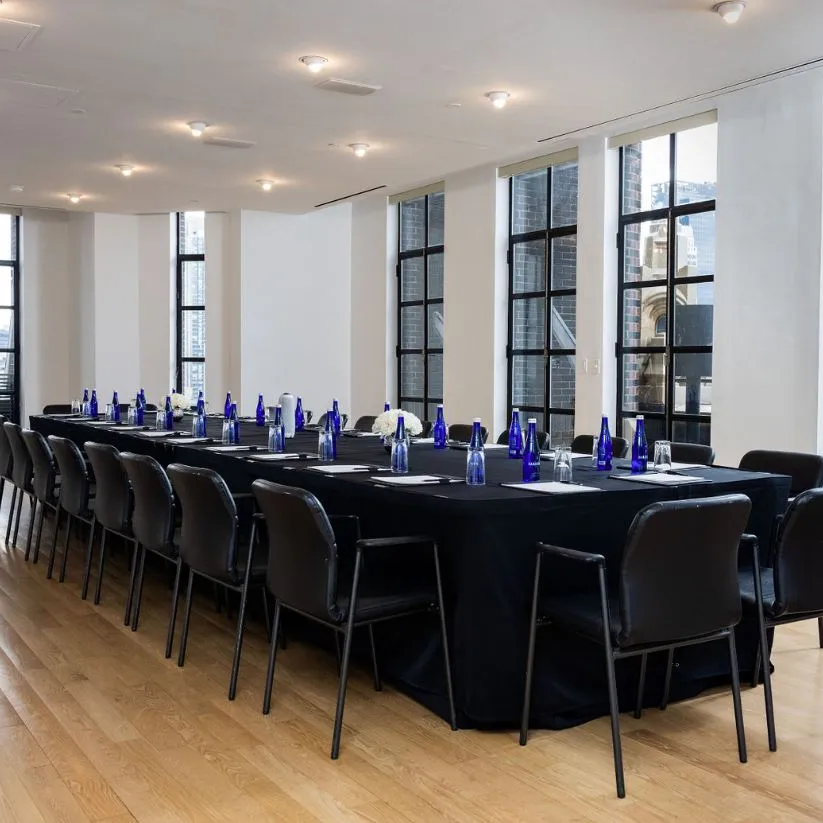 Conference Room set up boardroom-style with hardwood flooring